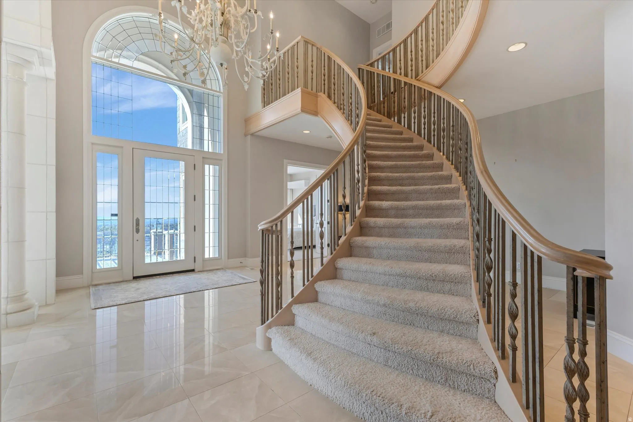 Entryway featuring a high ceiling and a chandelier