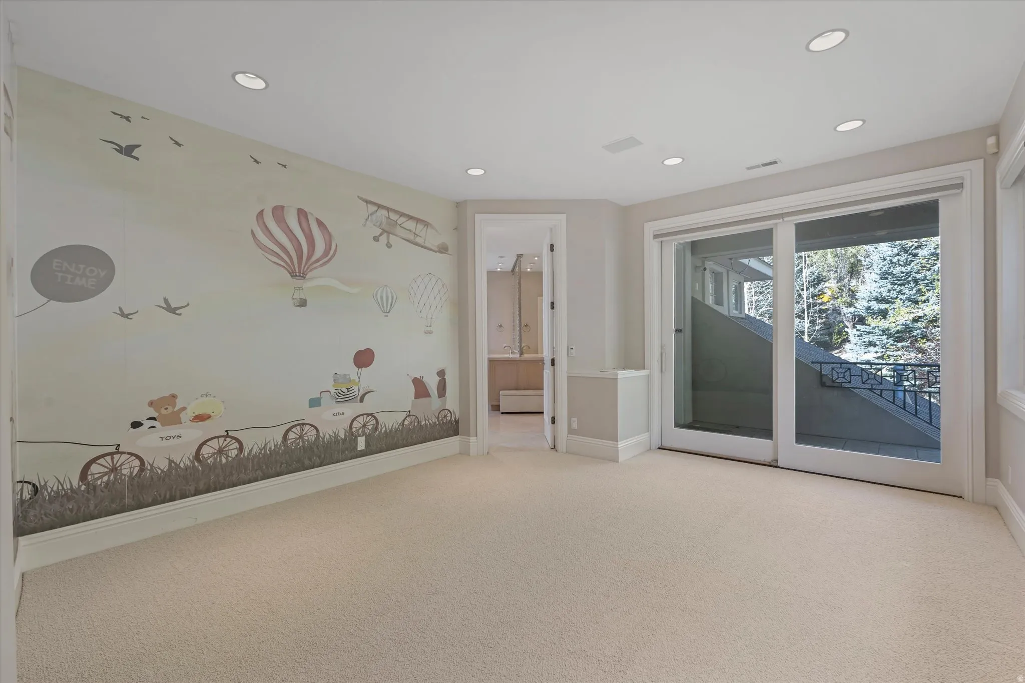 Empty room featuring light colored carpet and recessed lighting
