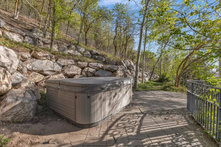 View of yard with a hot tub and a patio