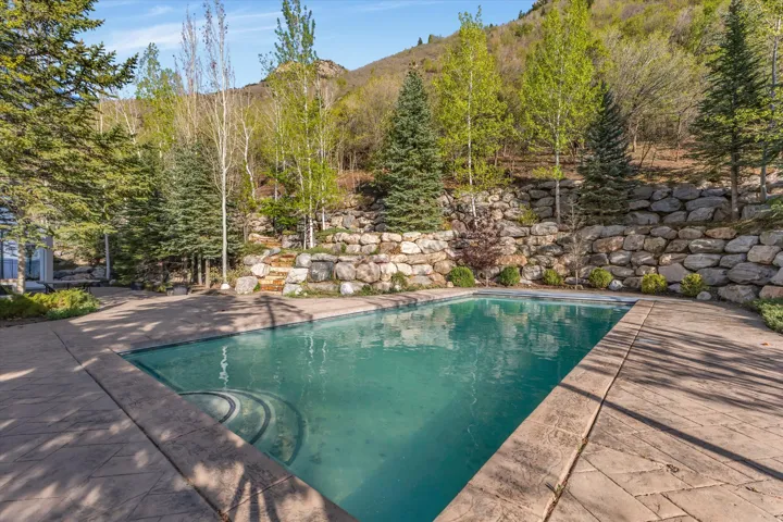 Swimming pool featuring a patio and a mountain view