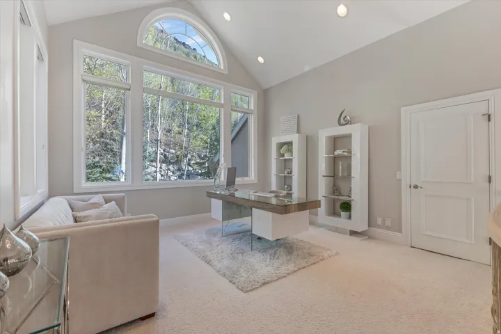 Office with light carpet, lofted ceiling, and recessed lighting