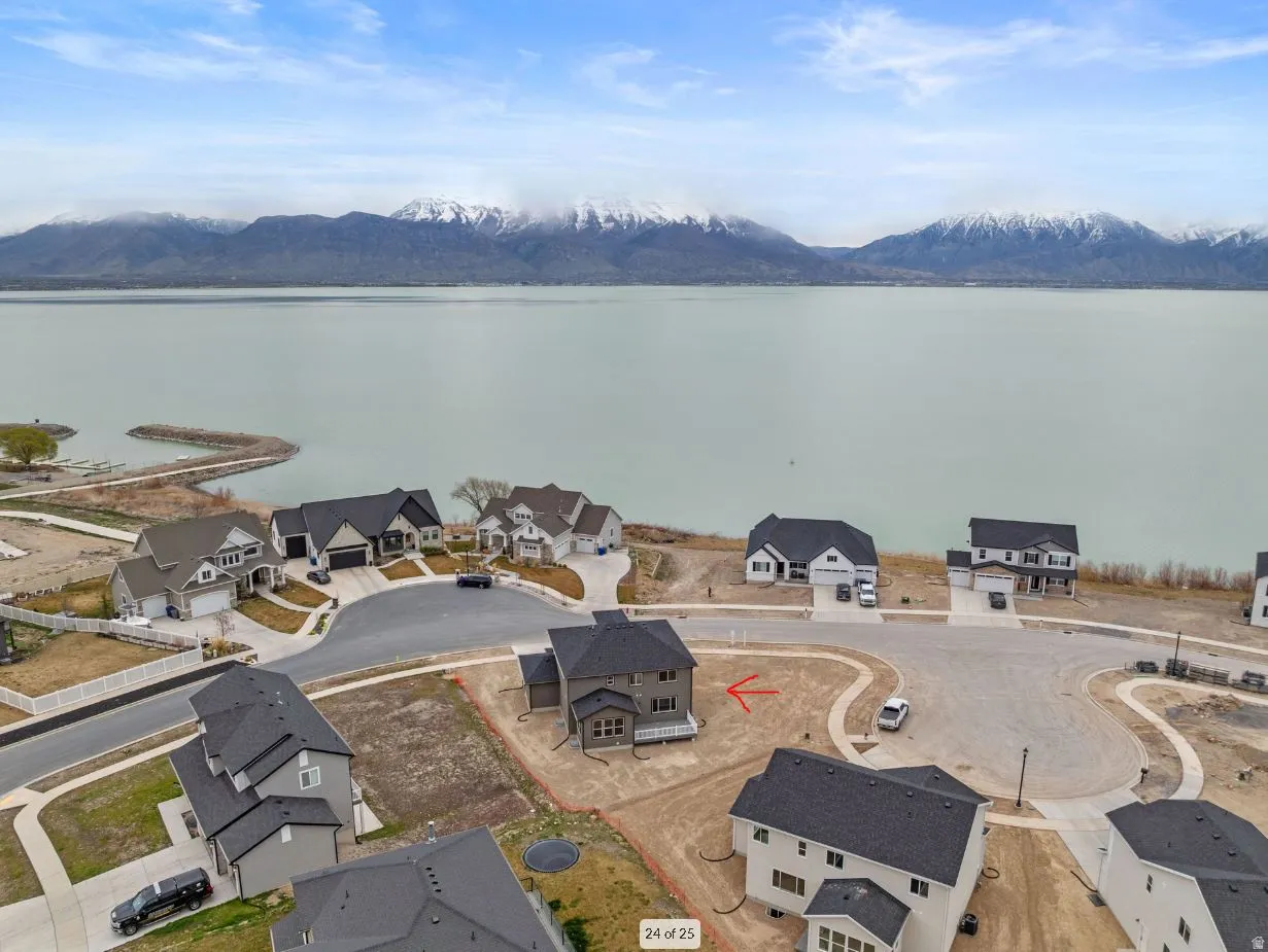 Water view featuring mountains and nearby neighbors
