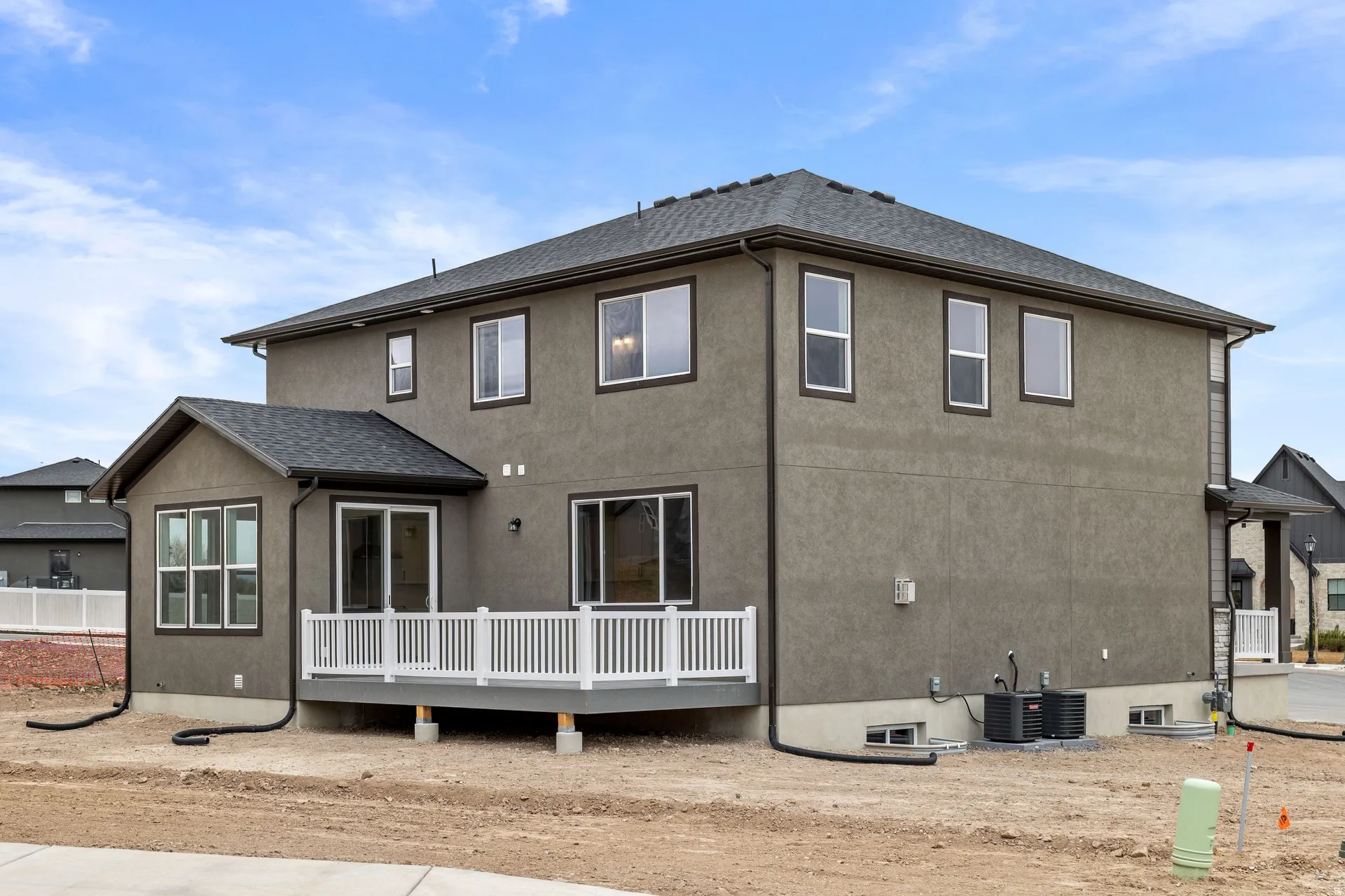 Back of house with a deck