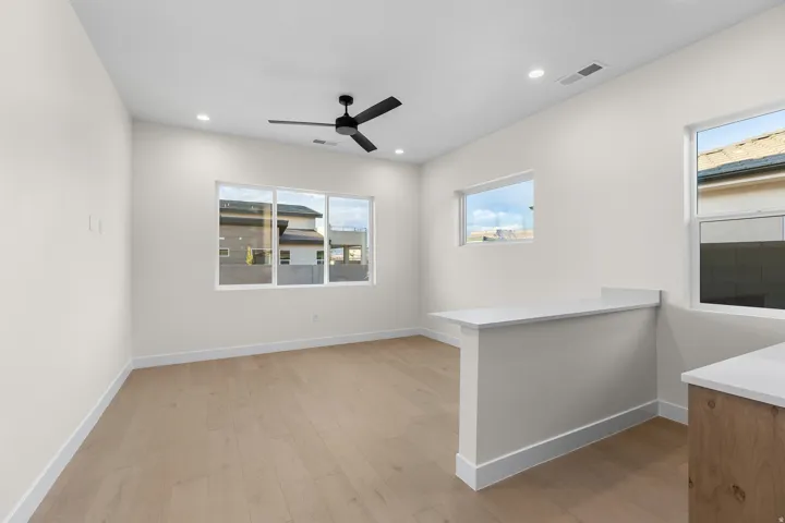 Unfurnished room with light wood-type flooring, a ceiling fan, and recessed lighting