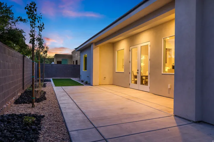 Patio terrace at dusk featuring a fenced backyard, a patio area, and french doors