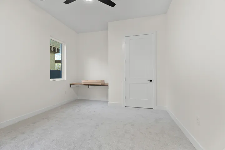 Unfurnished room with light carpet and a ceiling fan