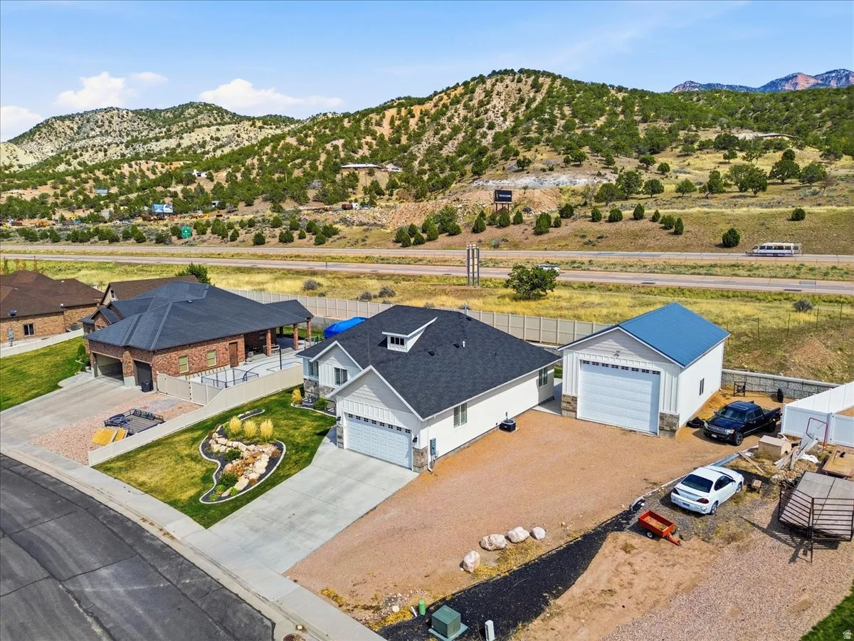 Aerial view of property and surrounding area featuring mountains