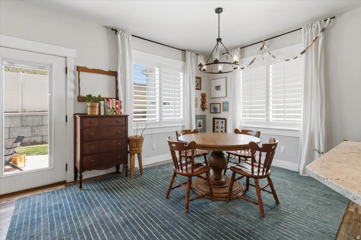 Dining space featuring suspended lighting and baseboards