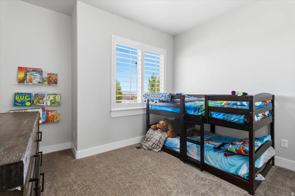 Carpeted bedroom featuring baseboards