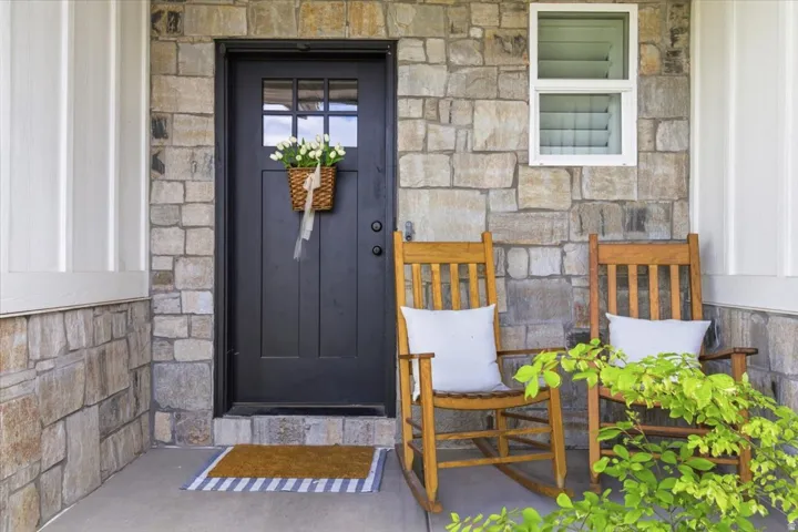 Doorway to property featuring stone siding