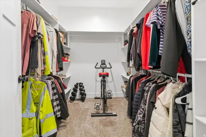 Walk in closet featuring light carpet