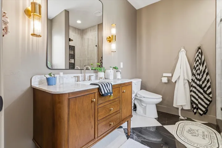 Full bathroom with a tile shower and vanity