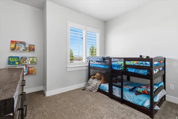 Carpeted bedroom featuring baseboards