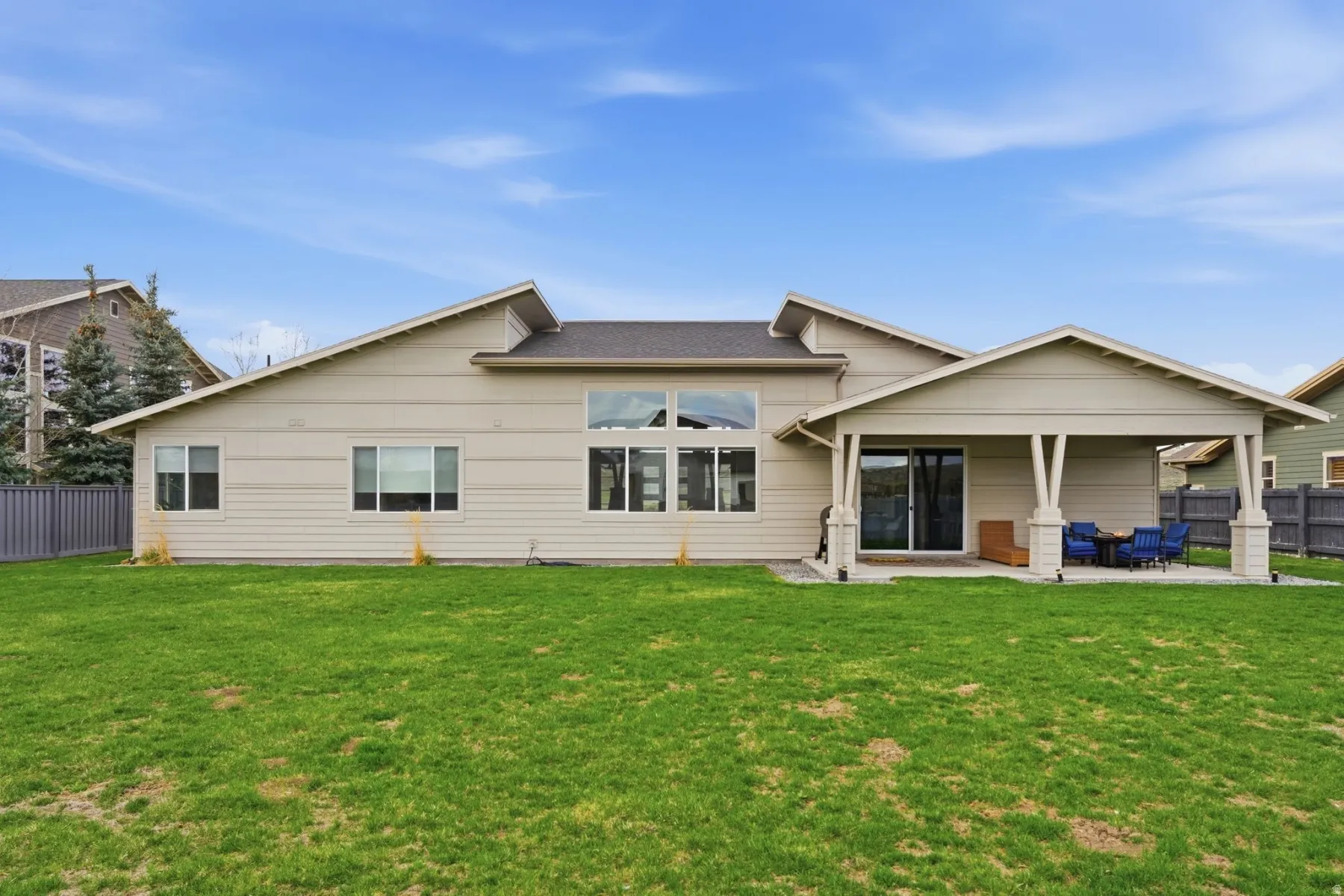 Rear view of property with a fenced backyard and a patio area