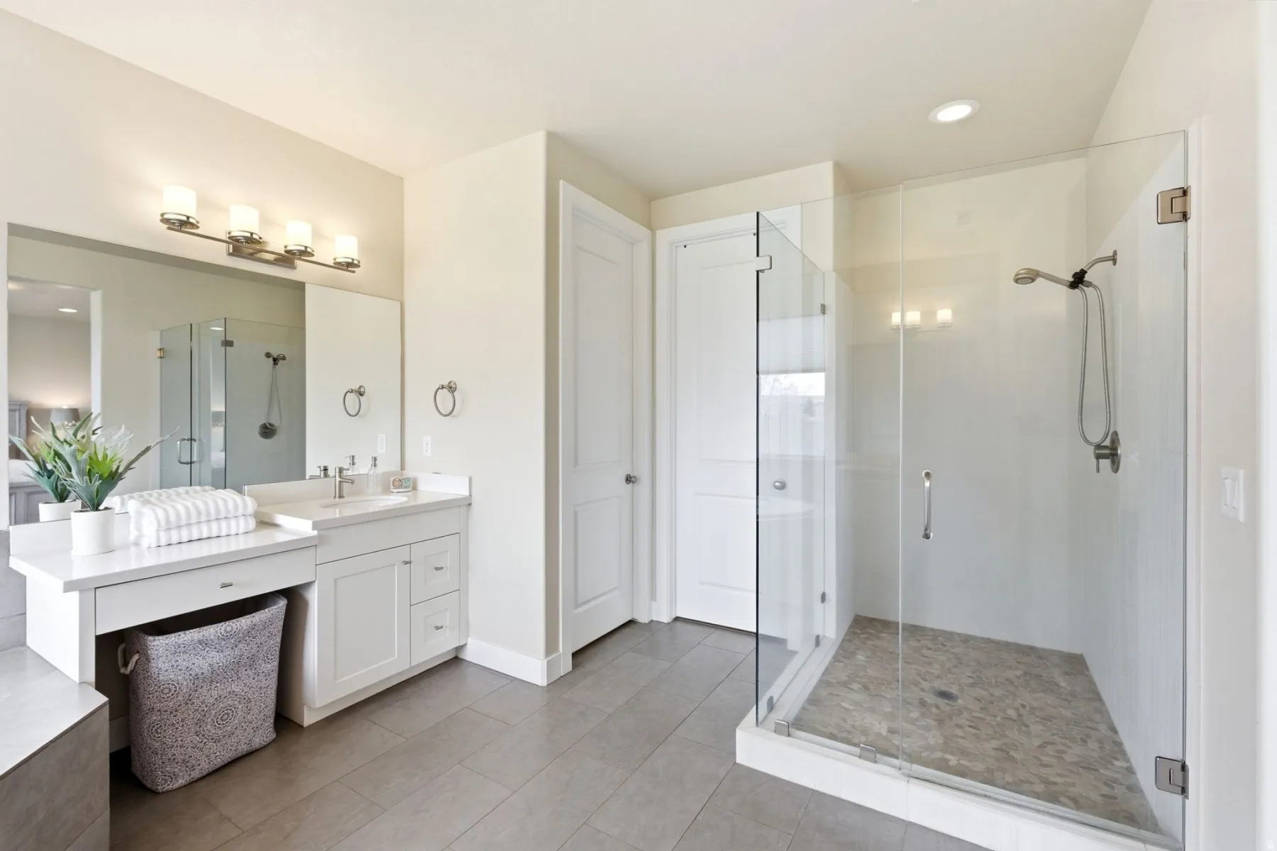 Full bath featuring vanity, a stall shower, light tile patterned floors, and recessed lighting
