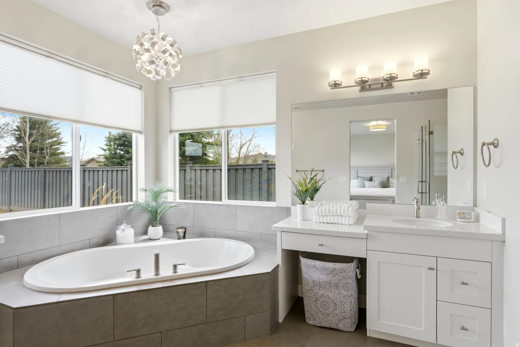 Full bath with ensuite bathroom, vanity, a bath, tile patterned flooring, and a chandelier