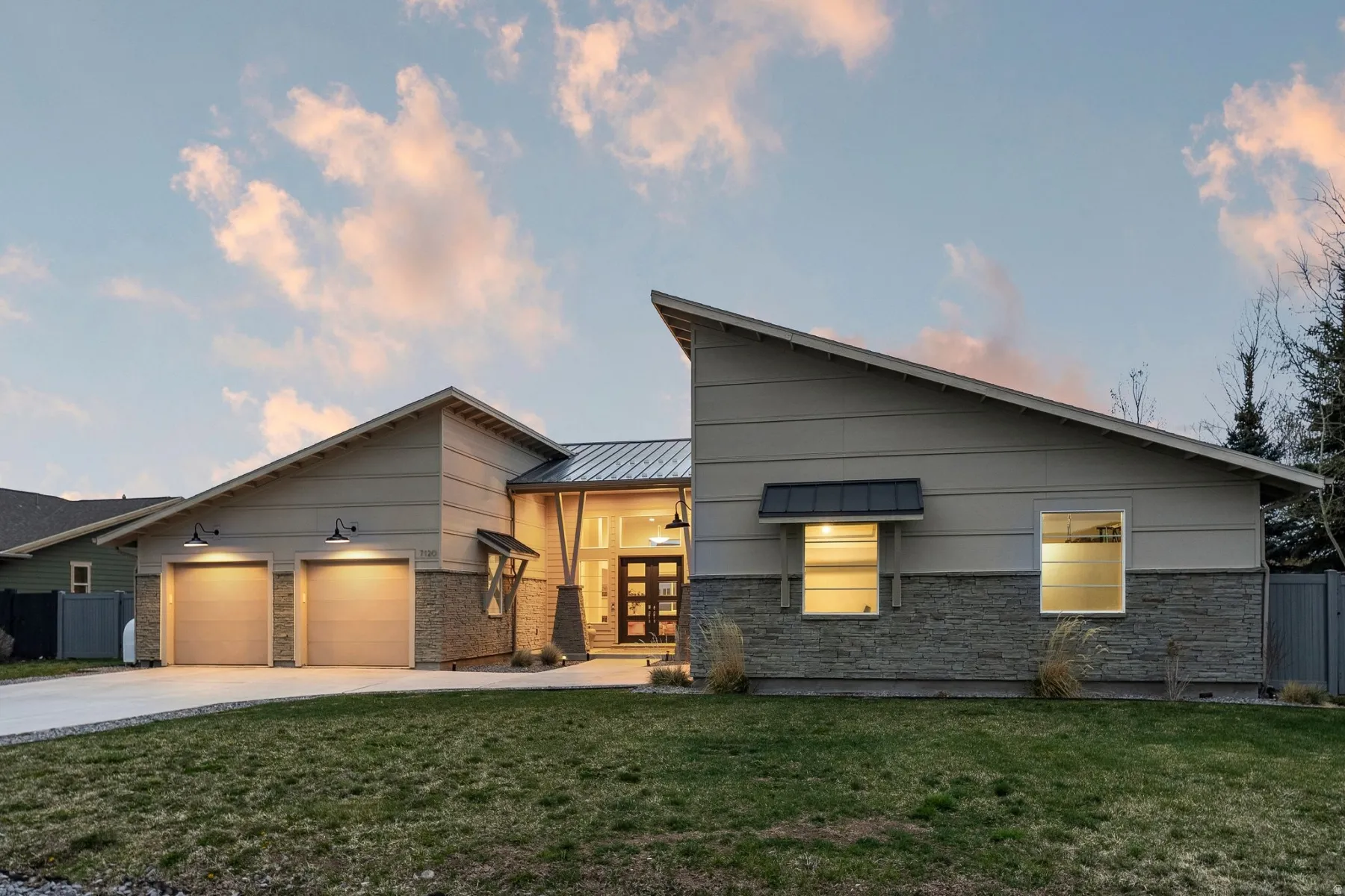 Contemporary home with driveway, french doors, an attached garage, and a metal roof