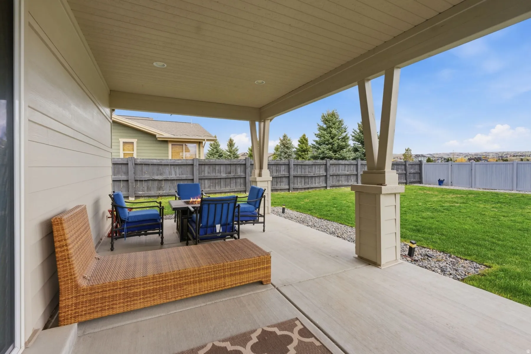 Fenced backyard with a patio area