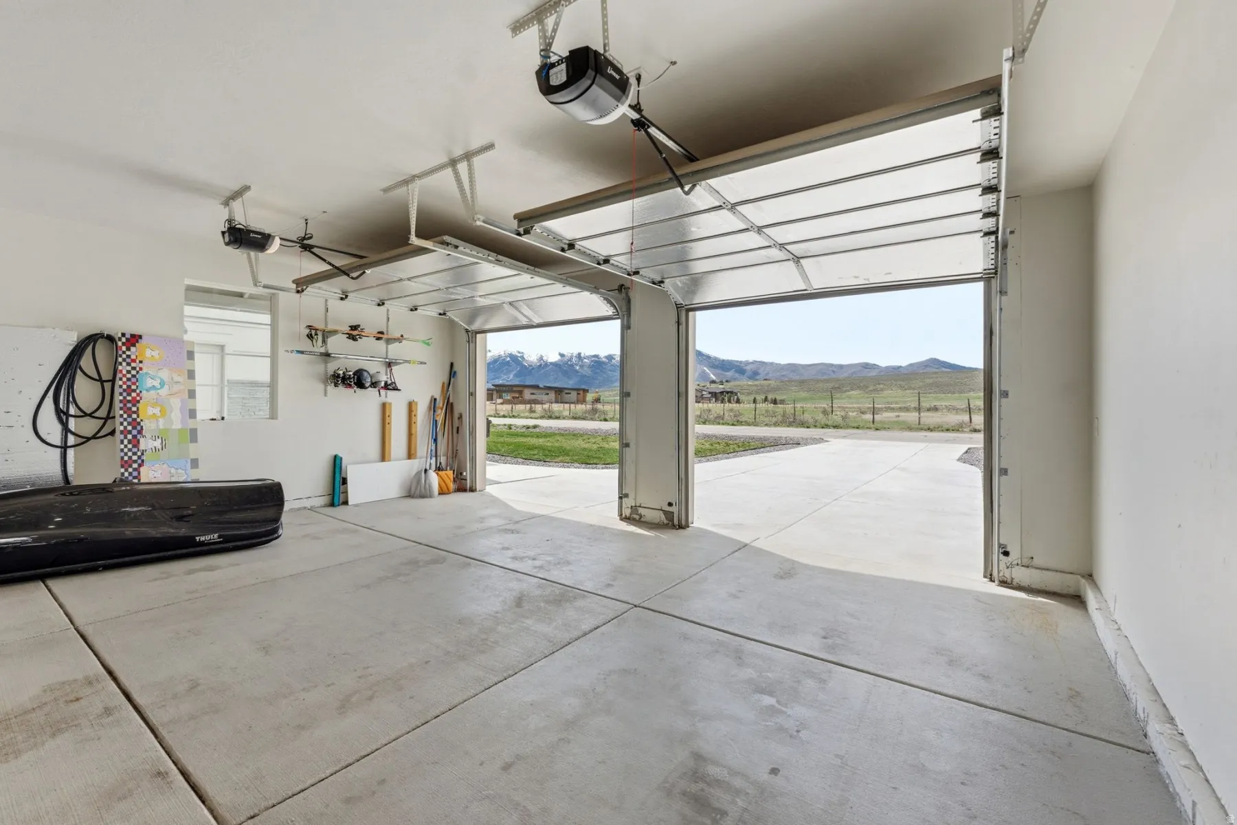 Garage featuring a mountain view and a garage door opener