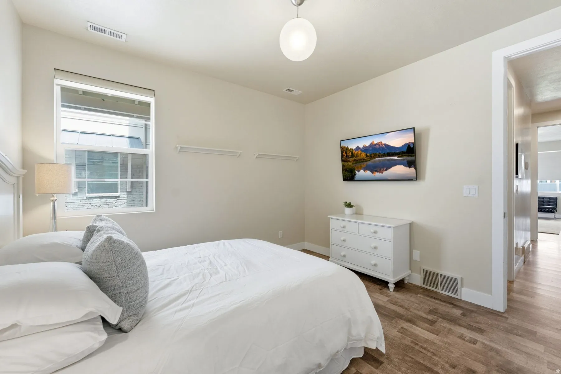 Bedroom featuring wood finished floors and baseboards