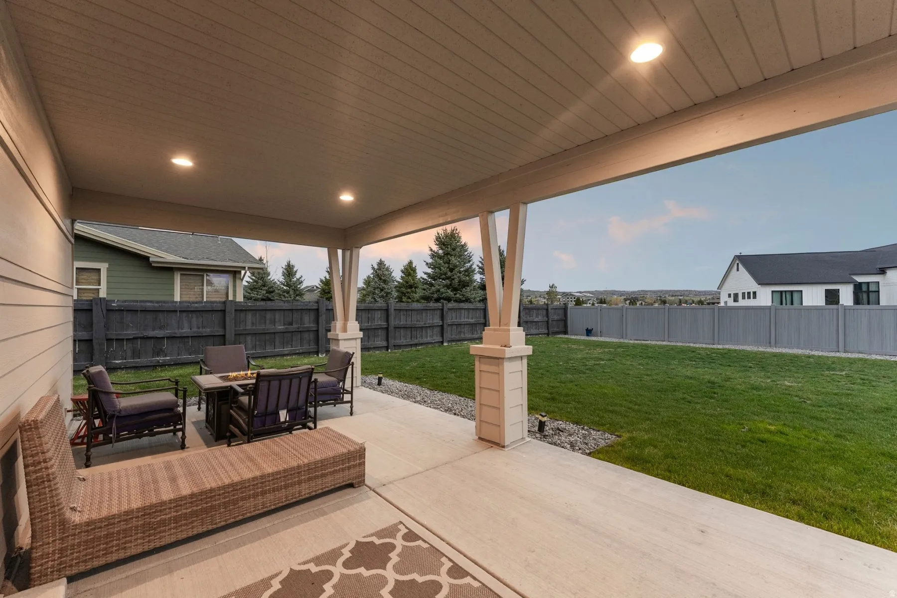 Fenced backyard featuring a patio area and outdoor lounge area