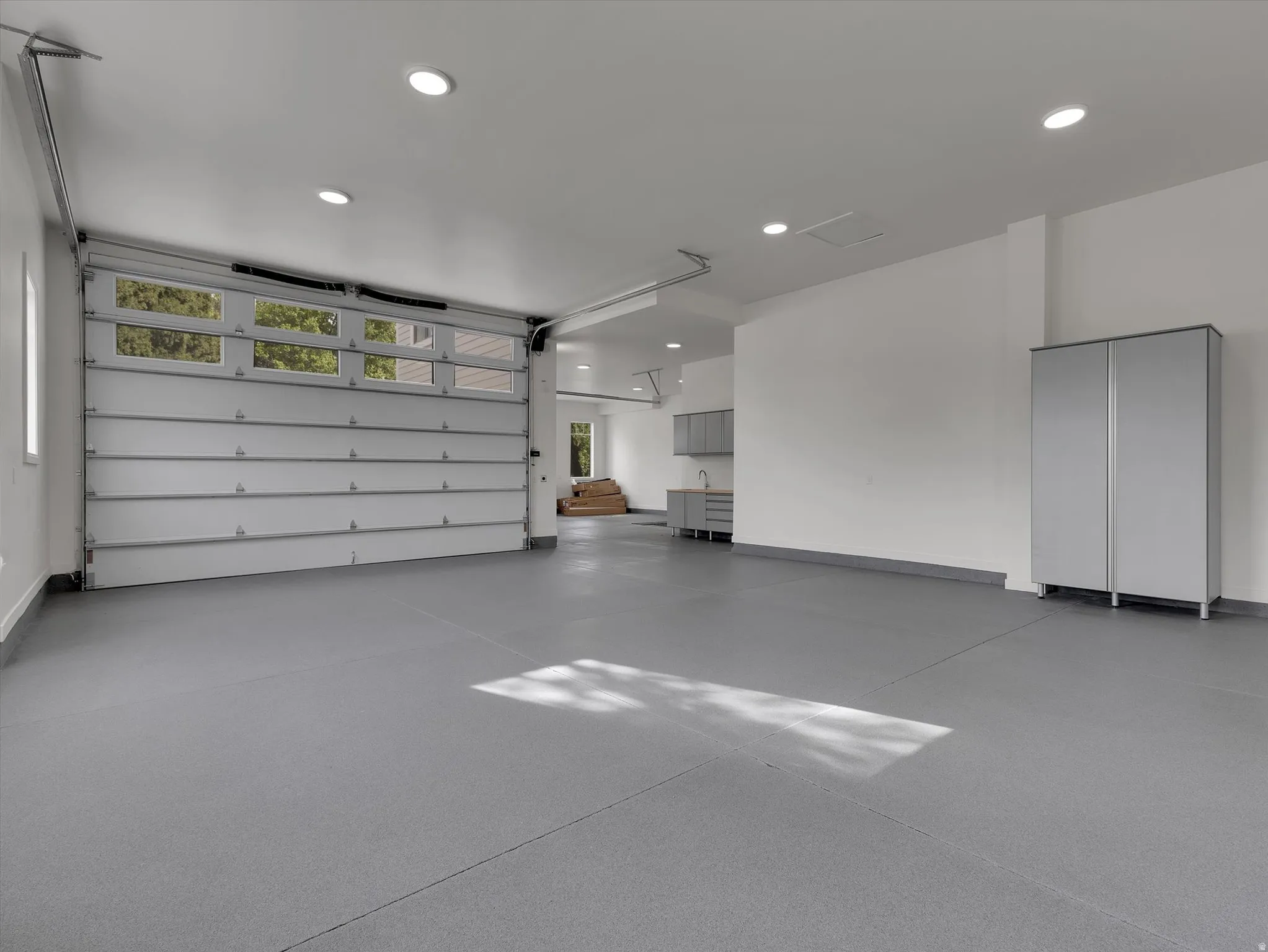 Garage featuring recessed lighting and baseboards