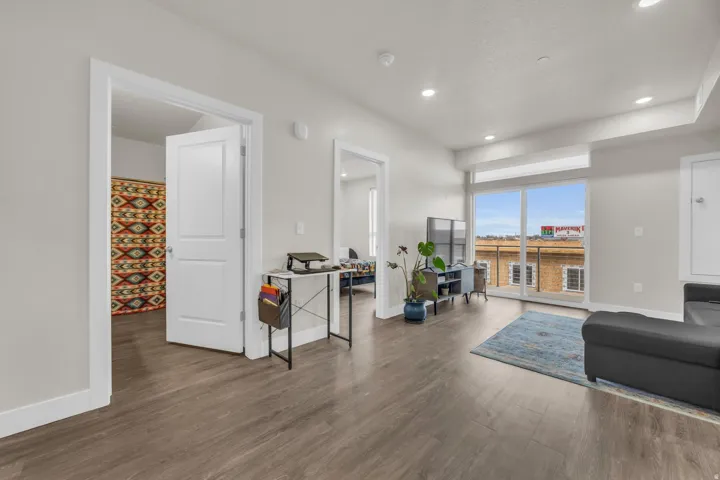 Living room featuring dark wood-type flooring and recessed lighting