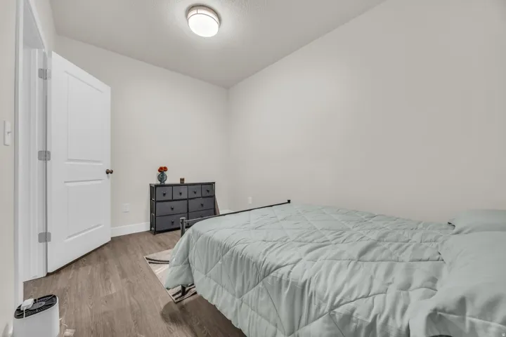 Bedroom featuring wood finished floors and a textured ceiling