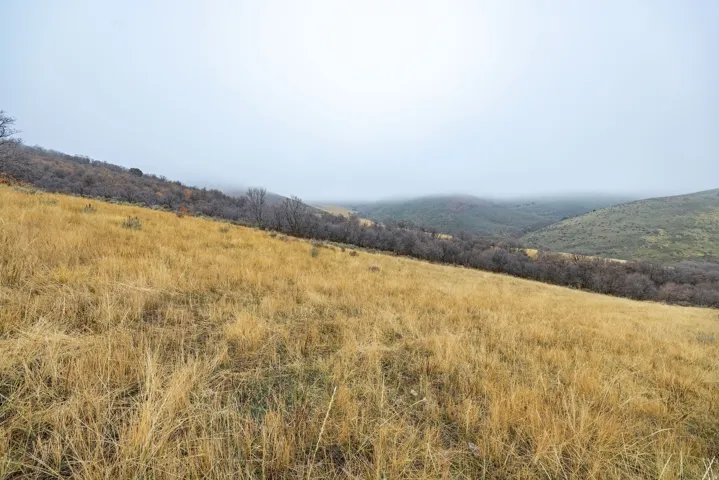 View of mountain backdrop with rural landscape