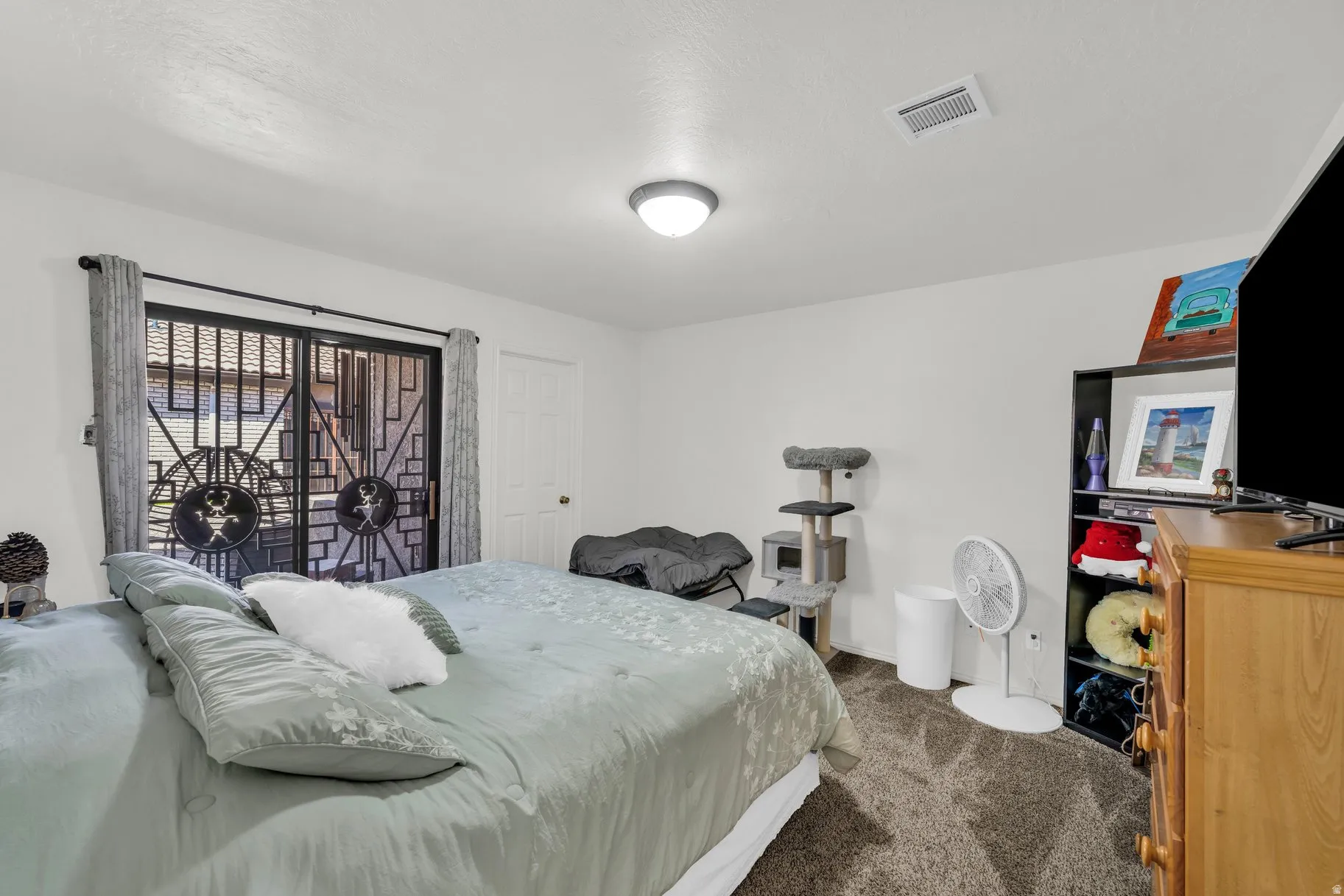 Bedroom with dark colored carpet and baseboards