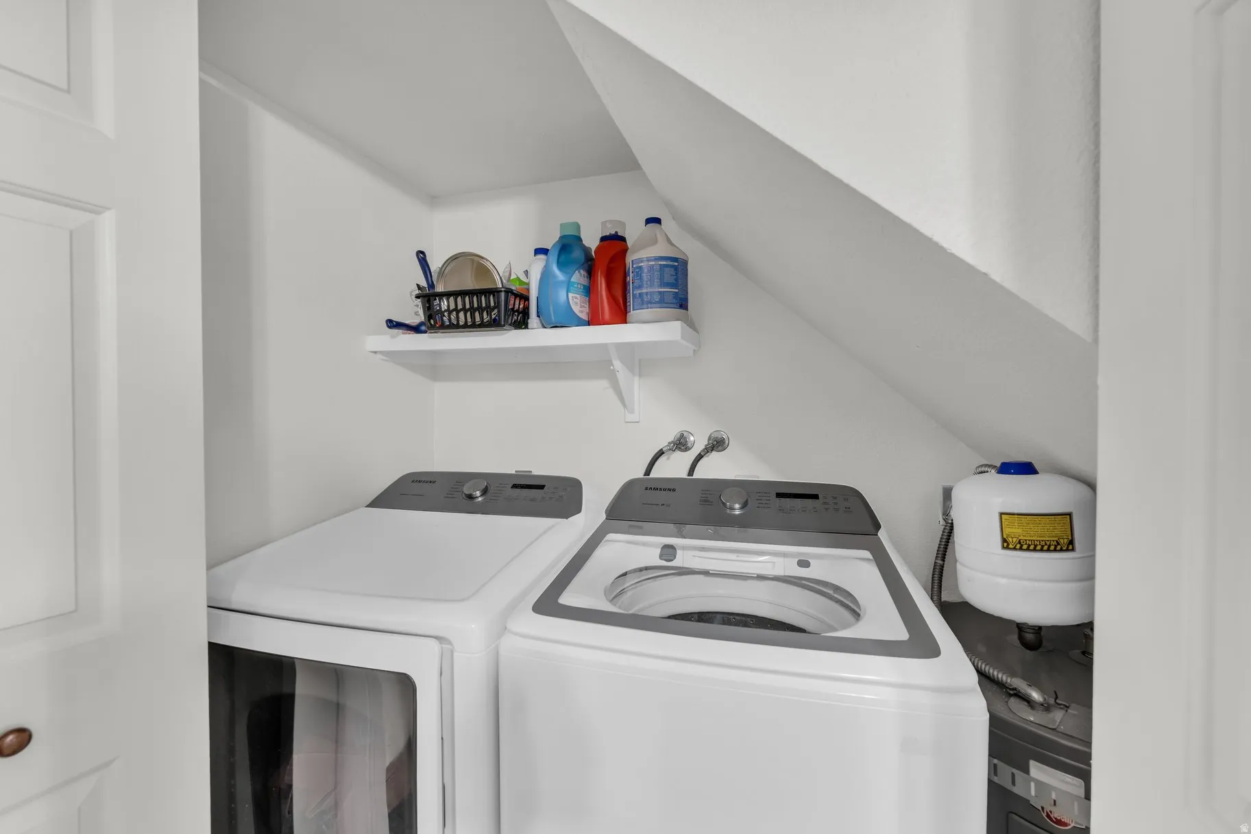 Laundry area featuring vaulted ceiling and washing machine and clothes dryer