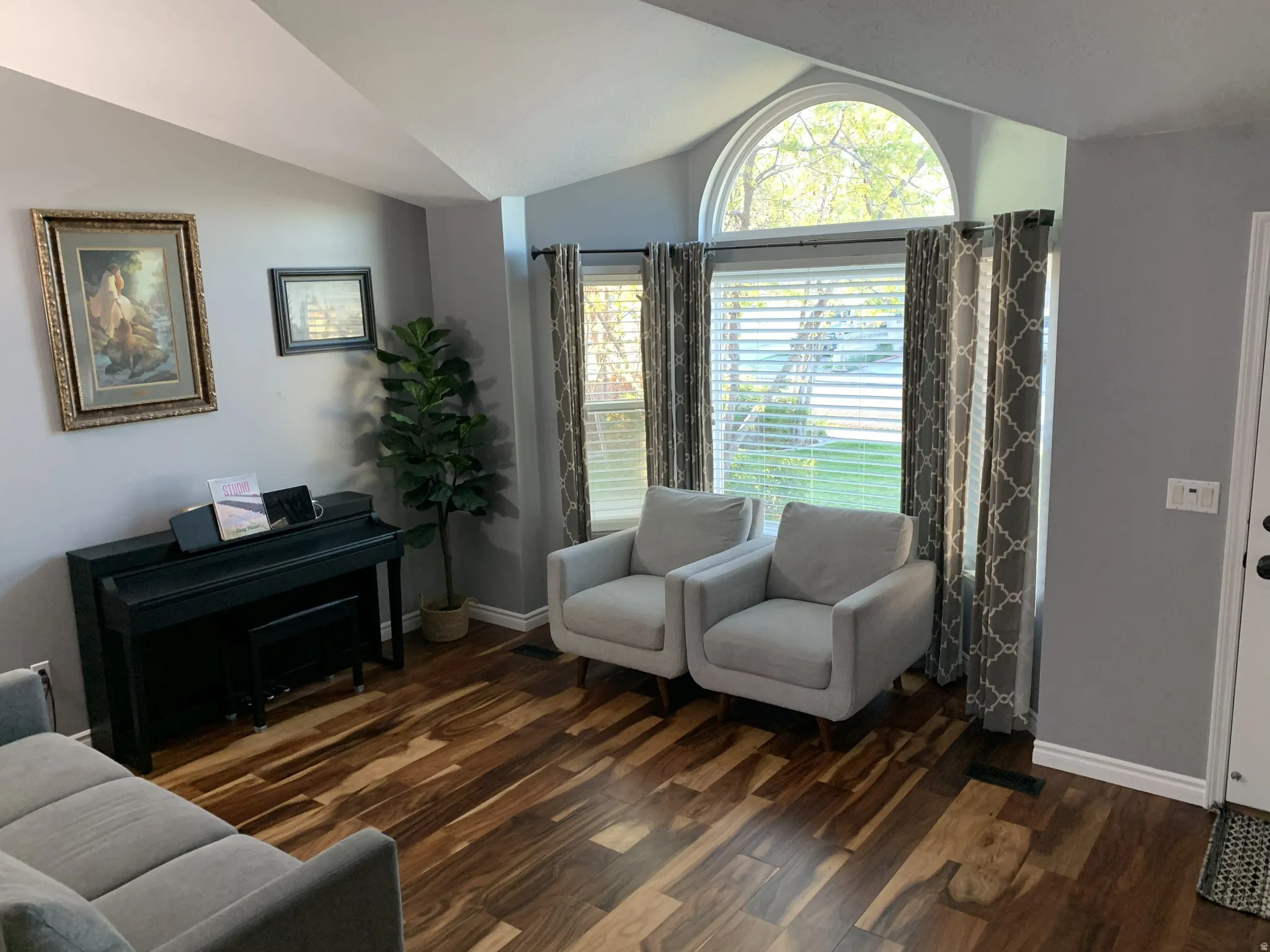 Living area with hardwood floors and lofted ceiling