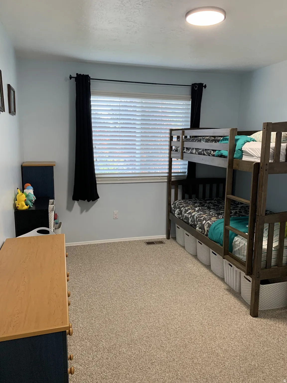 Bedroom featuring light carpet and baseboards