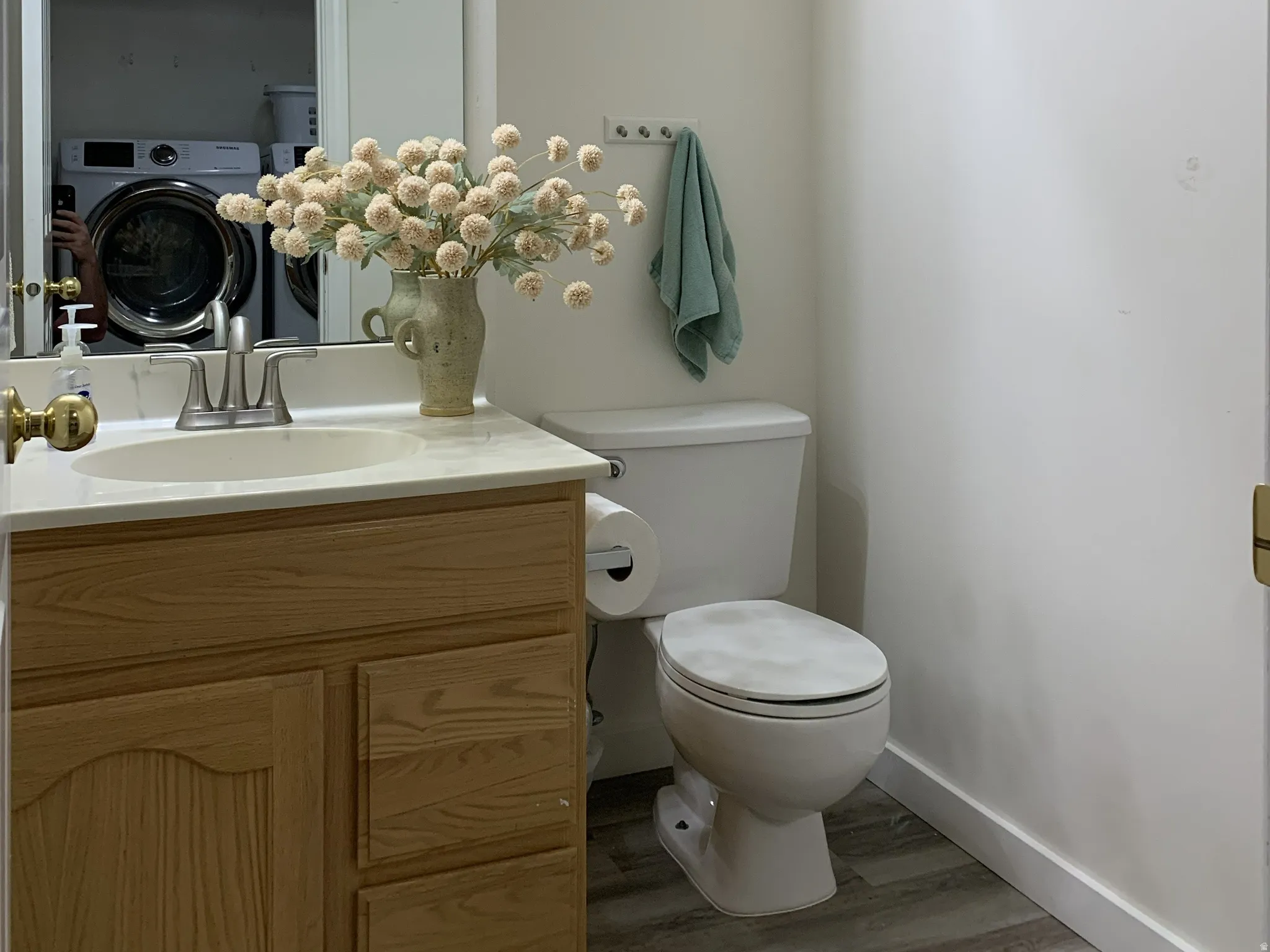 Half bath with vanity, a textured ceiling, and LVP style flooring