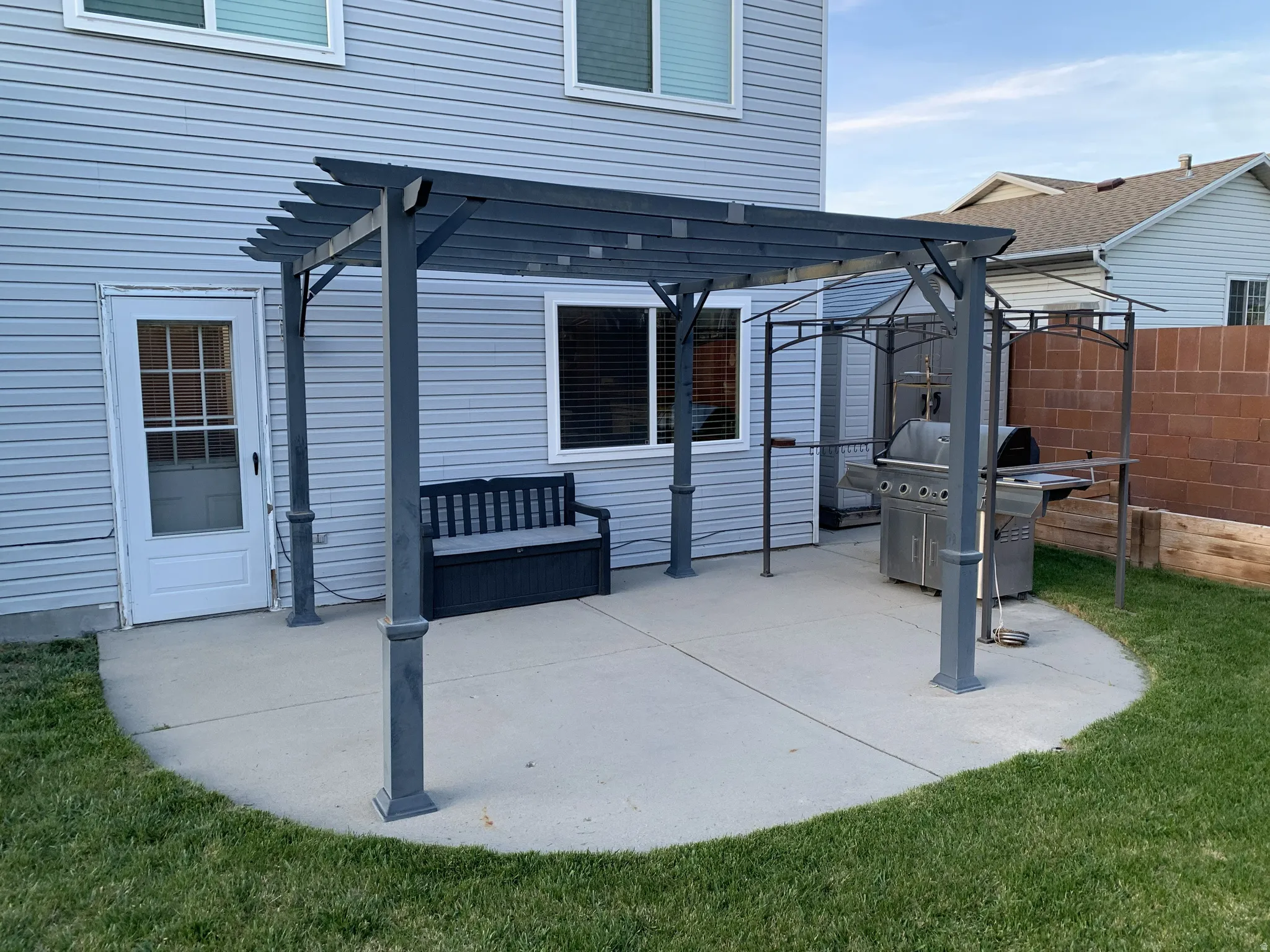 View of patio with a pergola and grilling area
