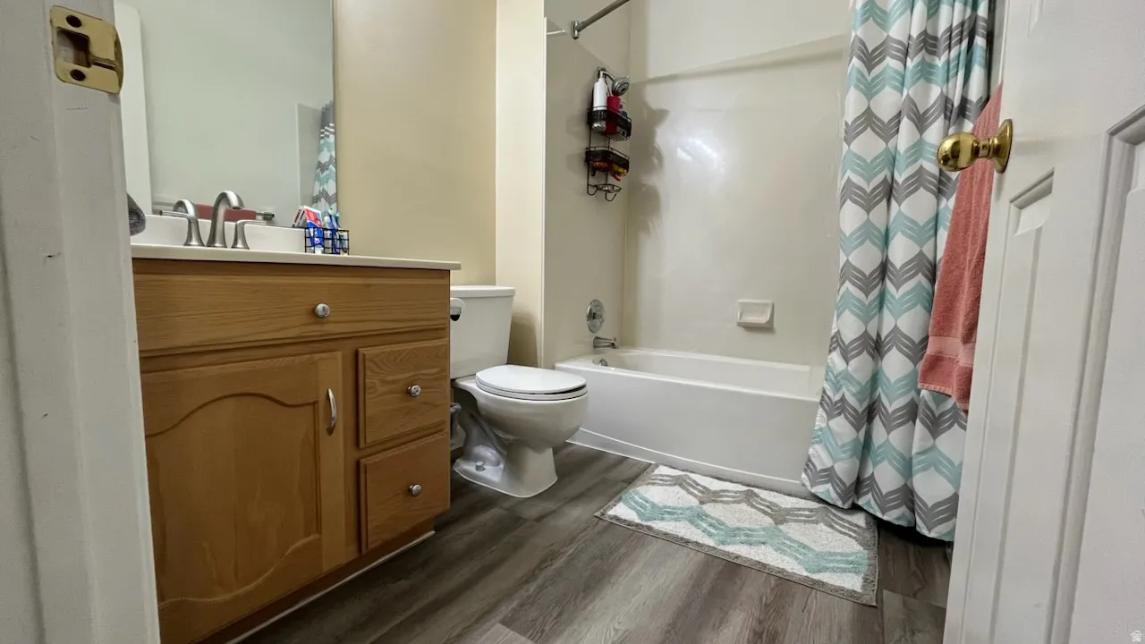 Full bathroom featuring vanity, LVP style floors, and shower / bath combo