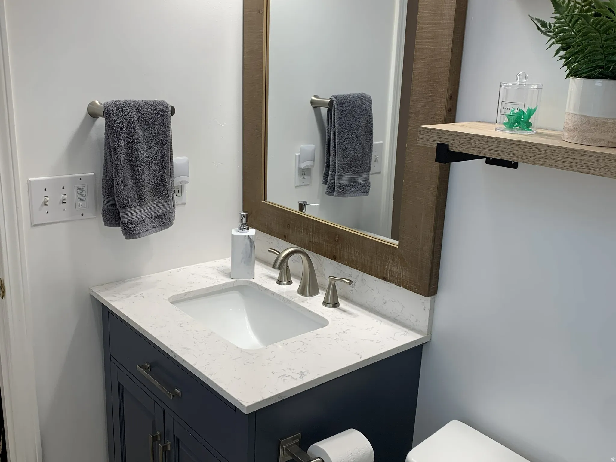Half bath featuring vanity and LVP finished floors