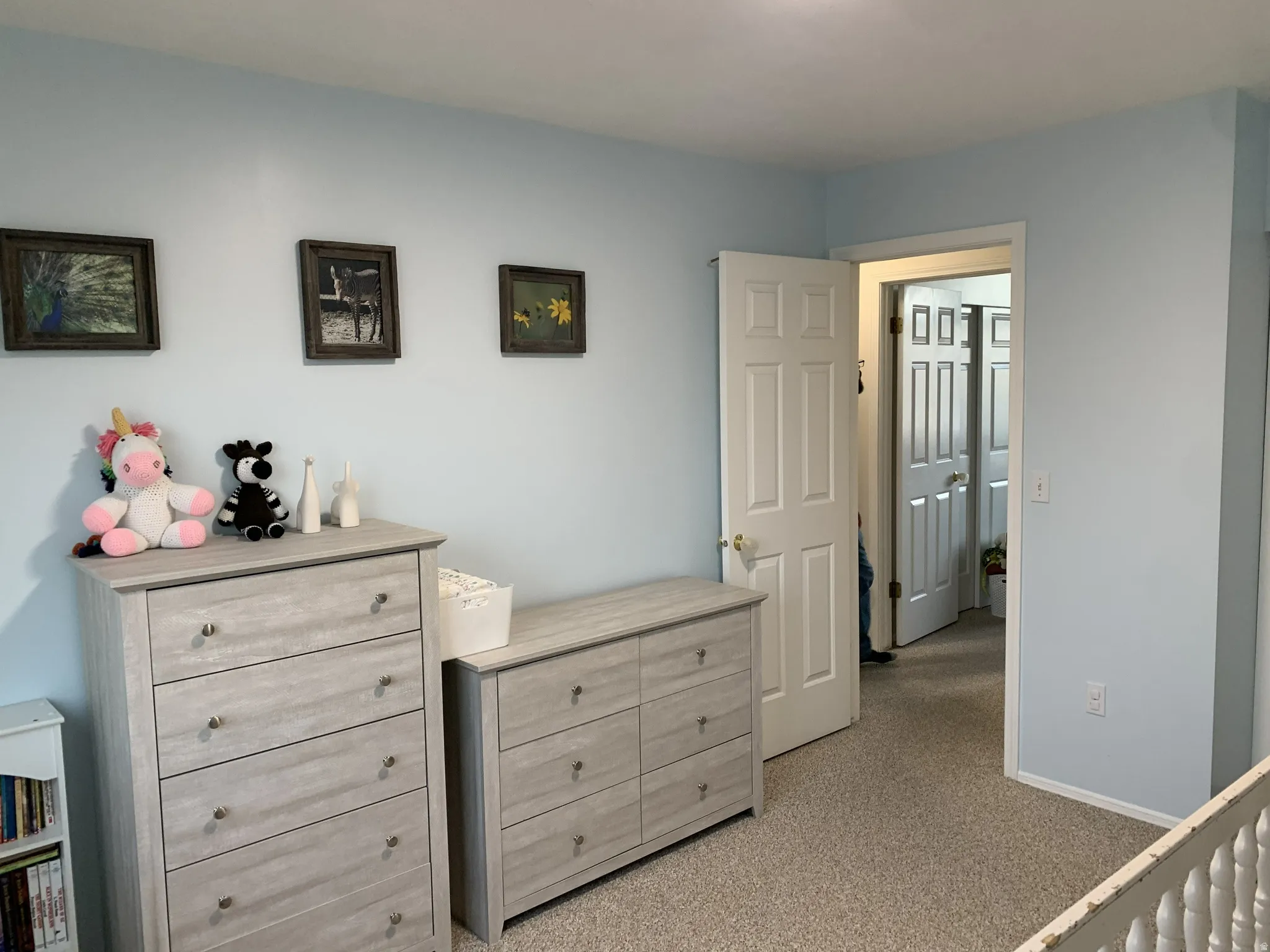 Bedroom with light colored carpet and baseboards