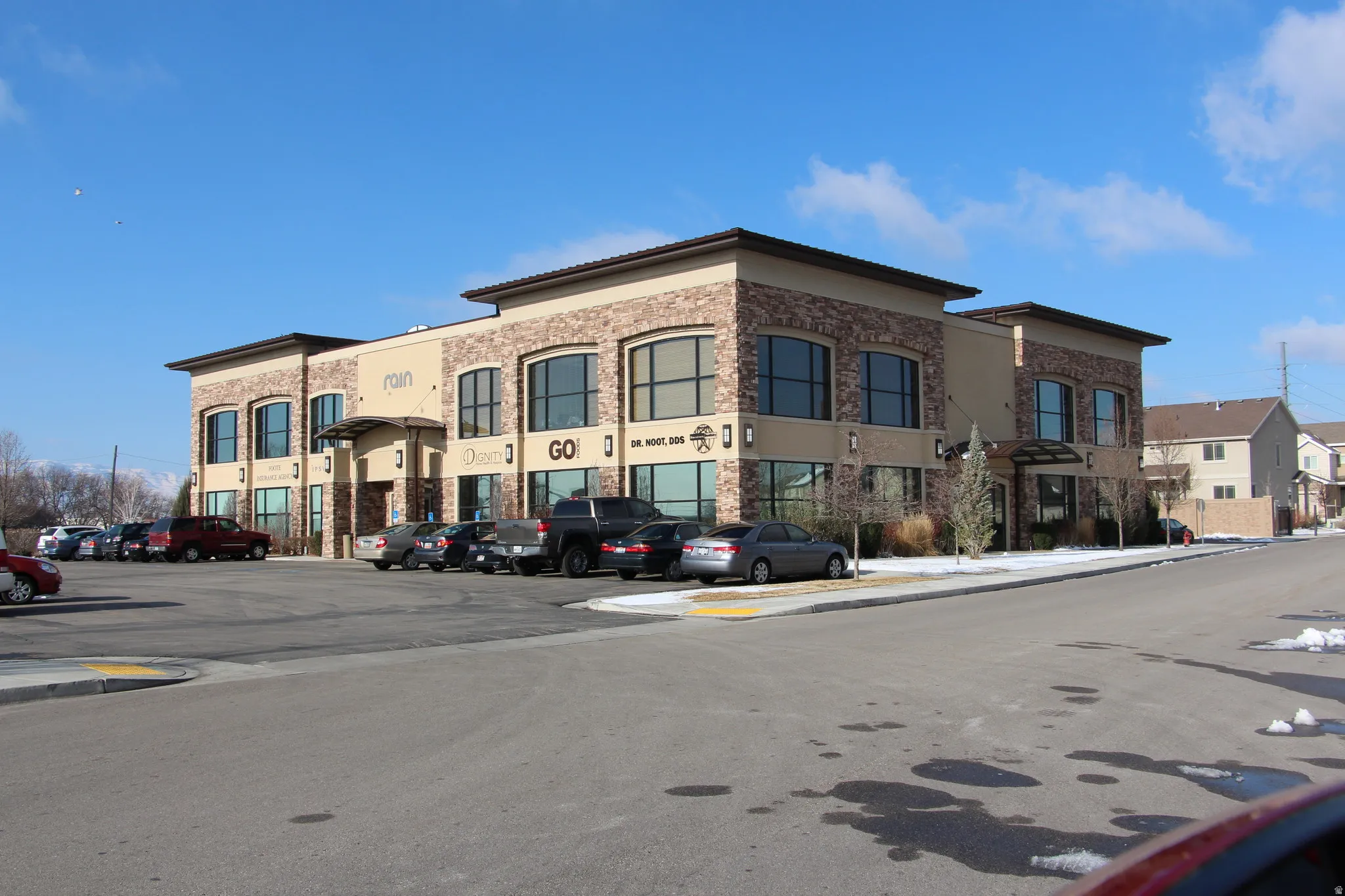 View of commercial property featuring uncovered parking