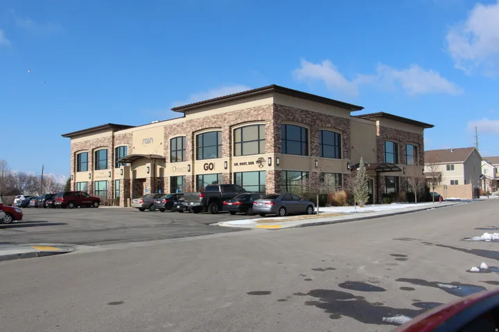 View of commercial property featuring uncovered parking