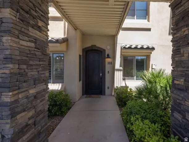 View of exterior entry featuring stucco siding