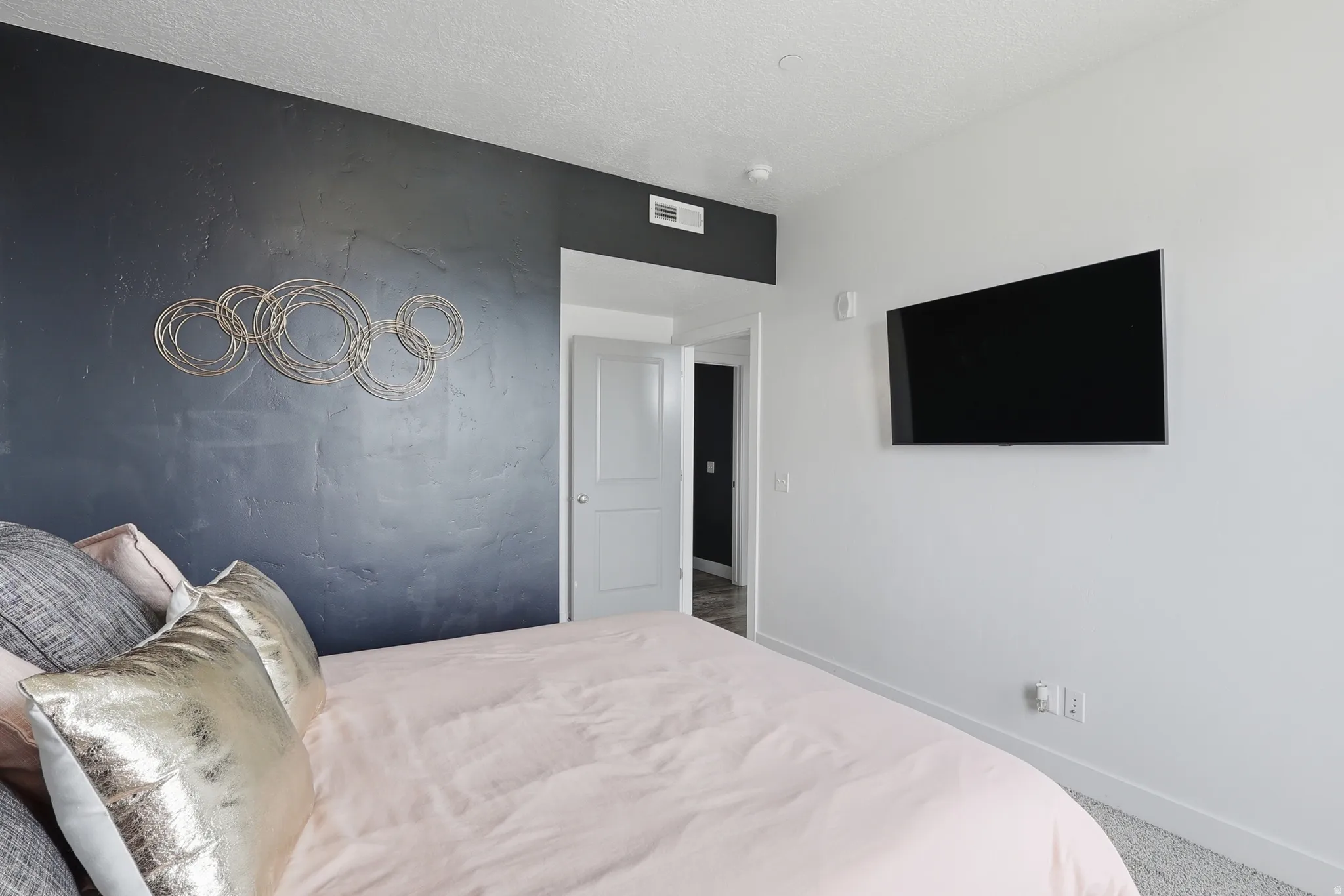 Carpeted bedroom featuring baseboards