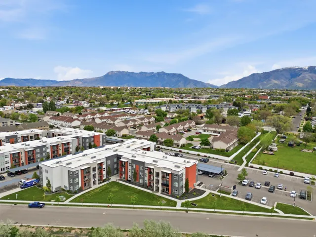 Aerial view of a mountain backdrop and apartment complex / building