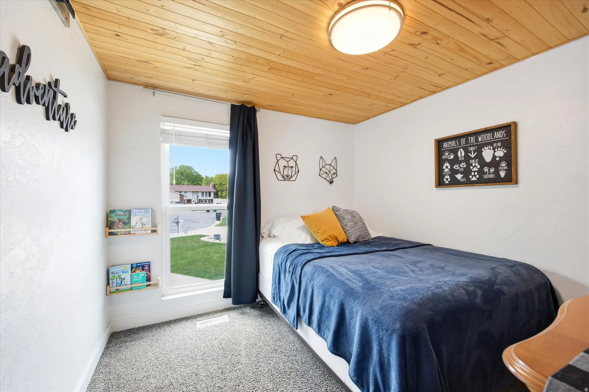 Bedroom featuring light carpet and wooden ceiling