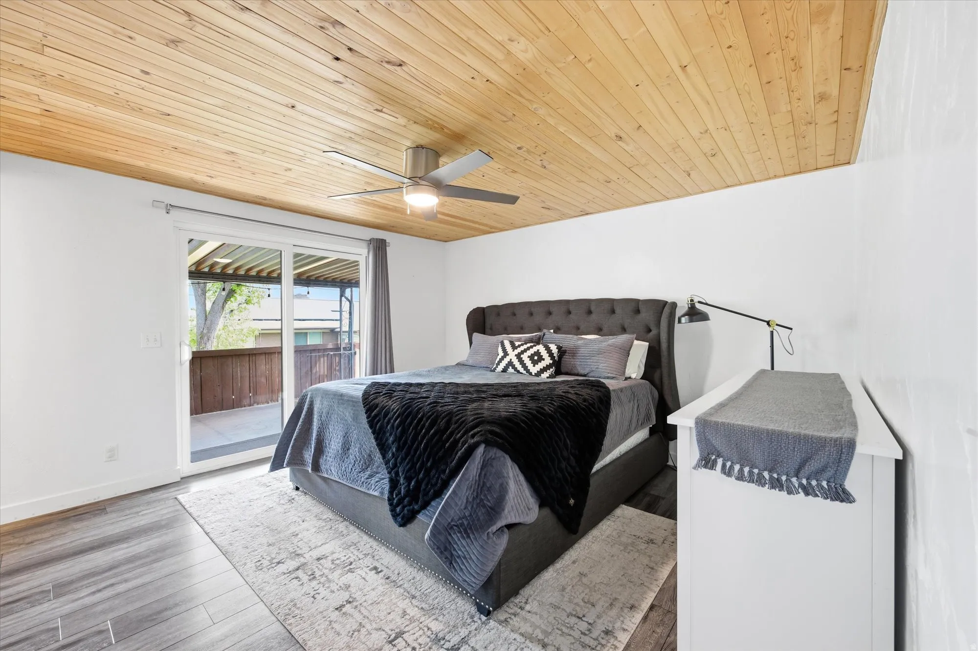 Bedroom featuring access to outside, wood finished floors, wooden ceiling, and ceiling fan