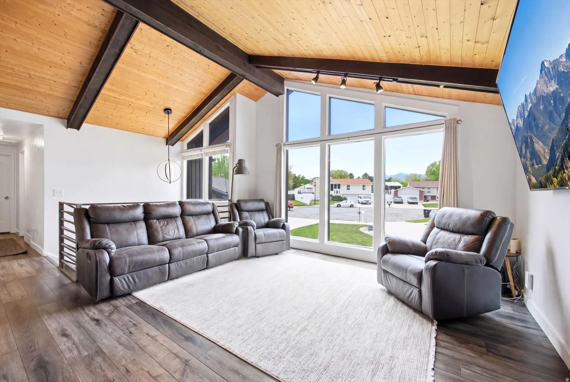 Living area featuring a high wooden beamed ceiling and dark wood-type flooring