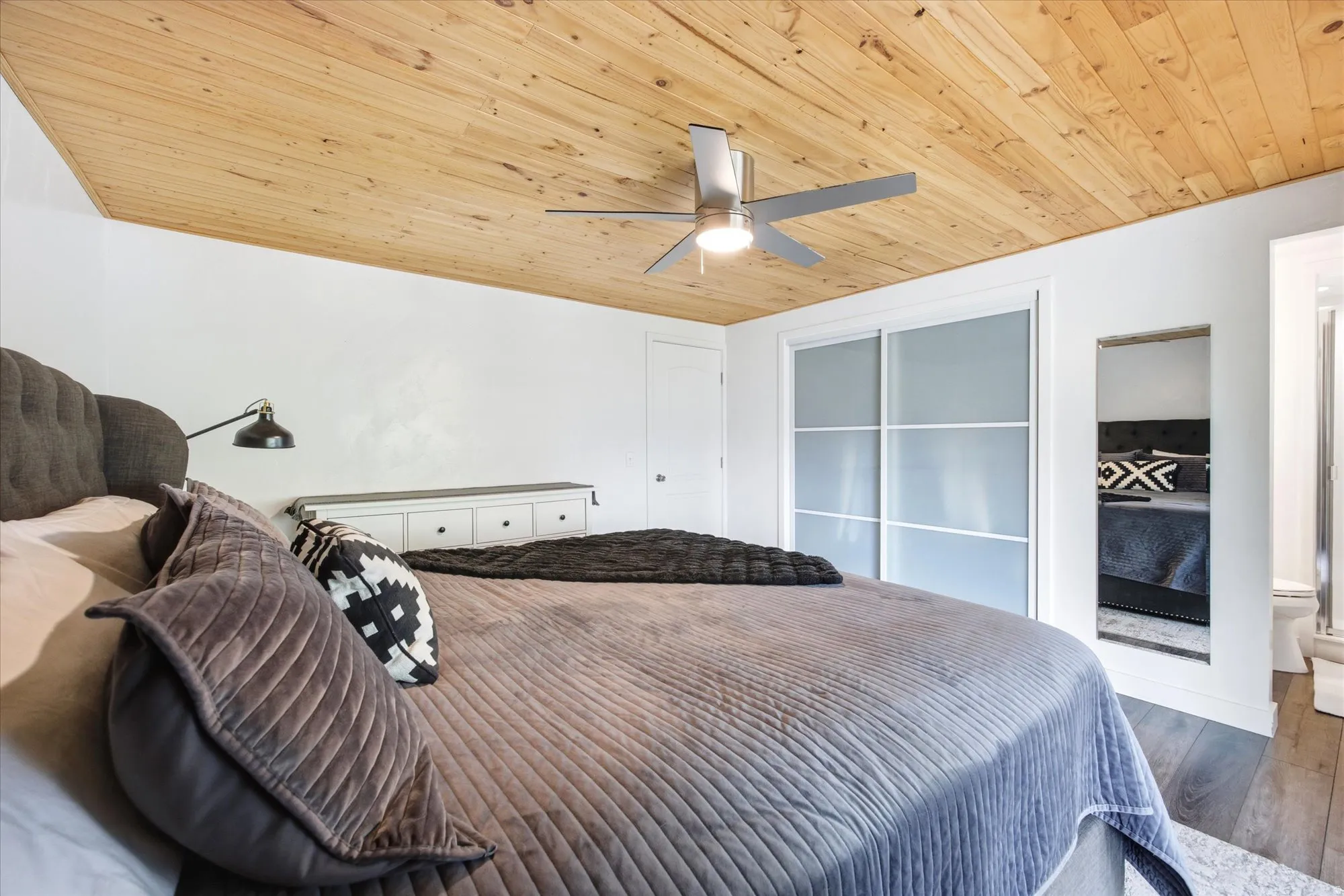 Bedroom with wood finished floors, wooden ceiling, and ceiling fan
