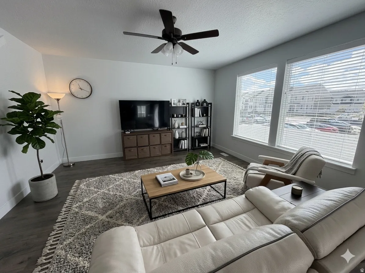 Living area featuring dark wood finished floors, ceiling fan, and a textured ceiling