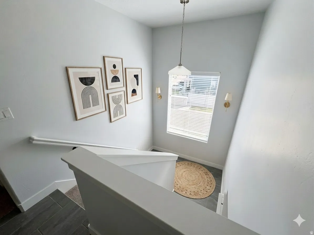 Staircase featuring baseboards and wood tiled floors