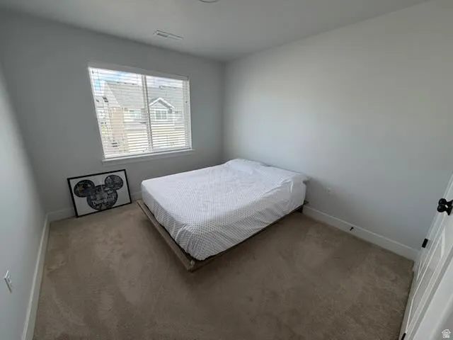 Carpeted bedroom with baseboards